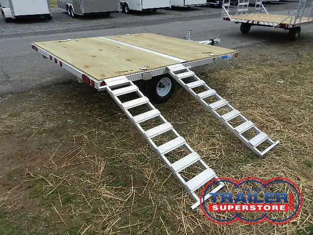 a trailer with stairs attached to it is parked in the grass