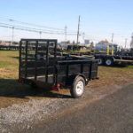 a black trailer parked on the side of the road
