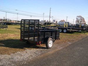a black trailer parked on the side of the road
