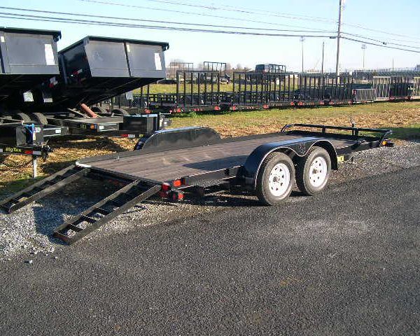 a flatbed trailer is parked on the side of the parking lot
