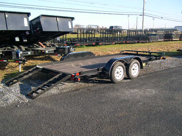 a flatbed trailer is parked on the side of the parking lot