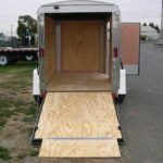 a trailer with a wooden ramp coming out of it