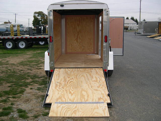a trailer with a wooden ramp coming out of it