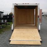 a trailer with a wooden floor is parked on the side of the road