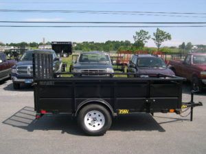 a black trailer is parked in a parking lot