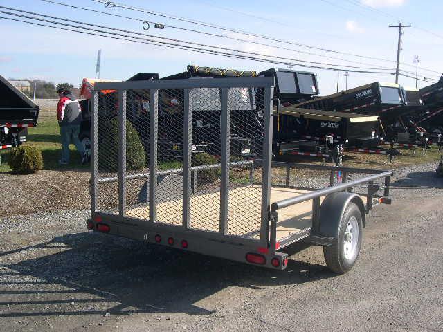a small trailer is parked on the side of the road