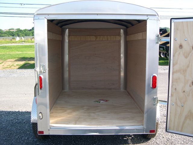 the inside of an empty small cargo trailer with the door open