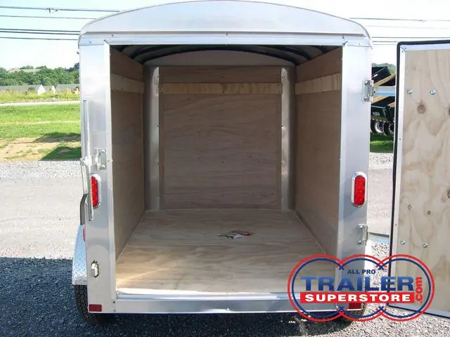 the inside of an empty small cargo trailer with the door open