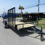 a black trailer parked on the side of the road