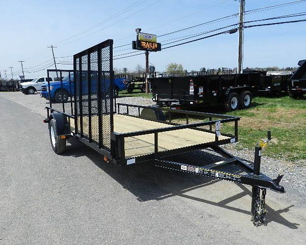 a black trailer parked on the side of the road