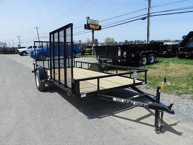 a black trailer parked on the side of the road