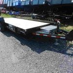 a CAM flatbed trailer is parked on the side of the road