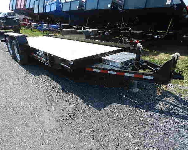 a CAM flatbed trailer is parked on the side of the road