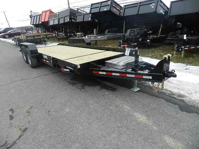 a wooden flatbed trailer is parked on the side of the road