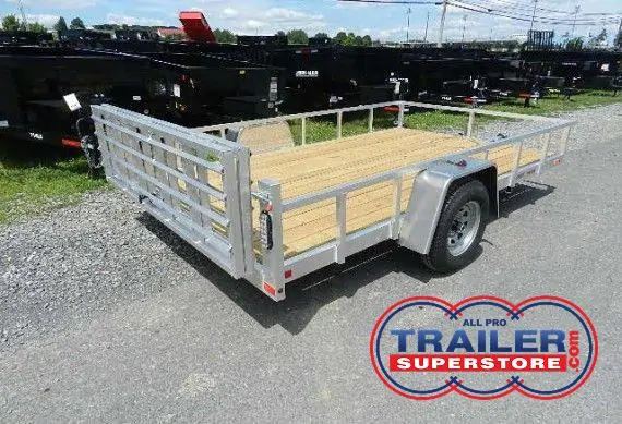 a trailer with a wooden deck parked on the side of the road