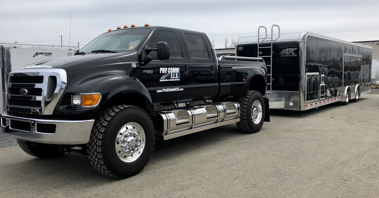 black pickup truck hauling atc trailer