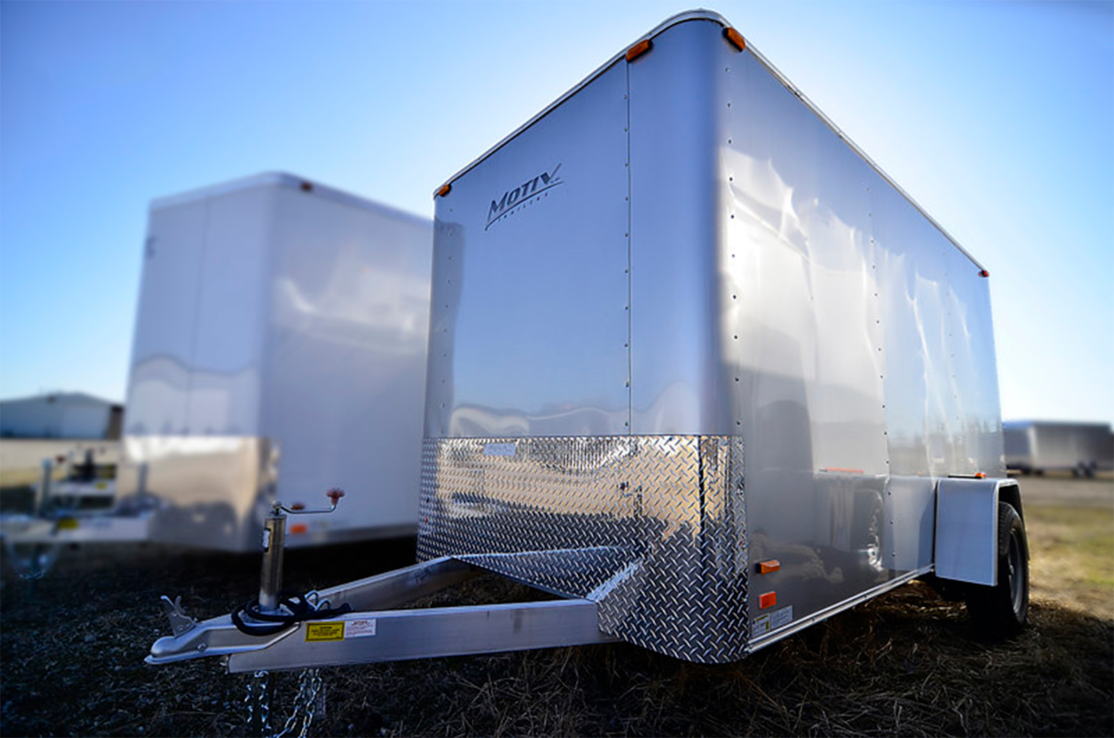 a silver trailer with a logo on the side