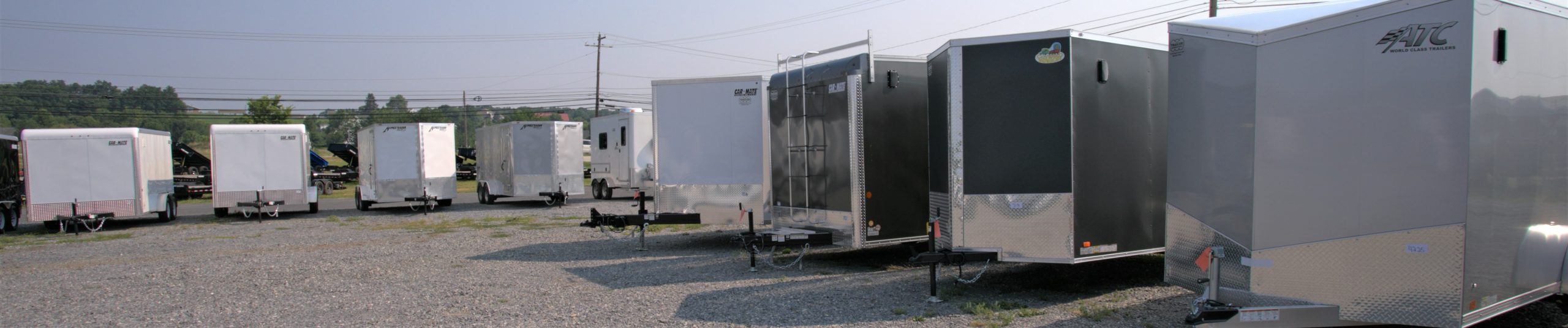 several enclosed cargo trailers parked