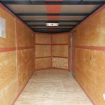 the inside of a Homesteader trailer with wooden walls and a wooden floor