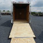 a 6x12 trailer with a wooden floor sitting in a gravel lot
