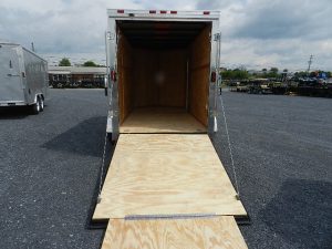 a 6x12 trailer with a wooden floor sitting in a gravel lot