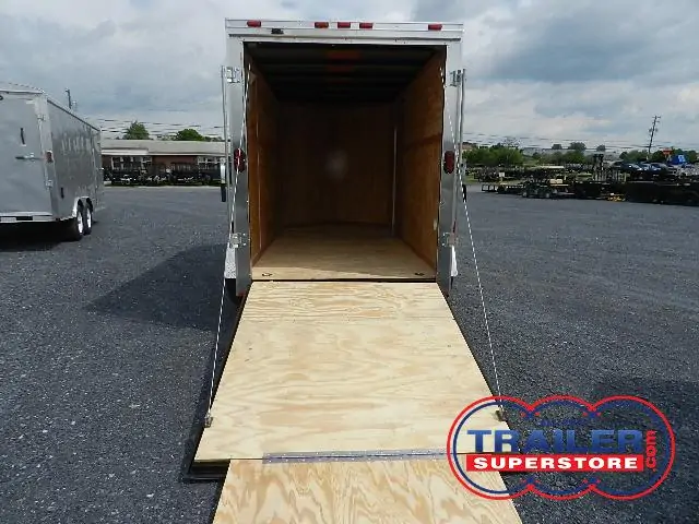 a 6x12 trailer with a wooden floor sitting in a gravel lot