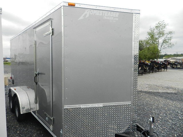 a homesteader trailer is parked in a gravel lot