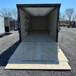 a trailer is sitting on top of a wooden platform in a gravel lot