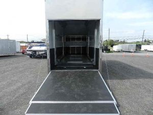 the inside of a trailer with the door open in a parking lot