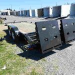 a Big Tex trailer parked next to a row of trailers