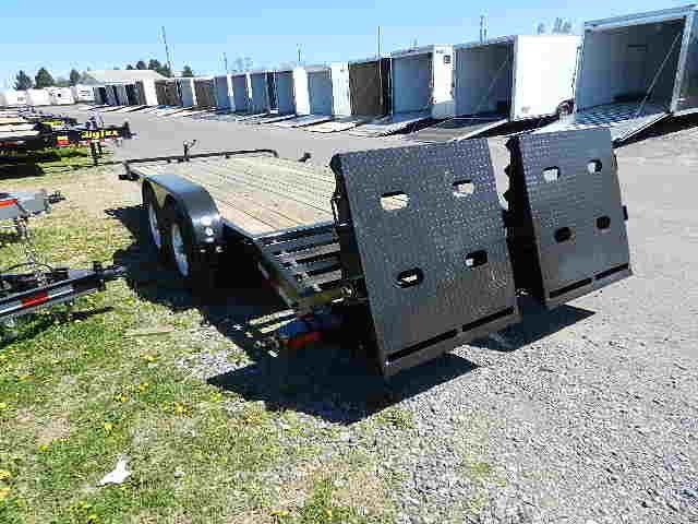 a Big Tex trailer parked next to a row of trailers
