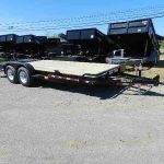 a big tex flatbed trailer is parked on the side of the road