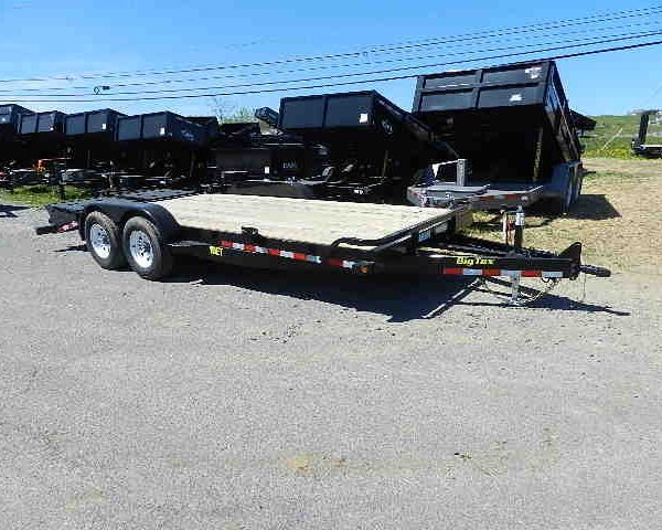 a big tex flatbed trailer is parked on the side of the road