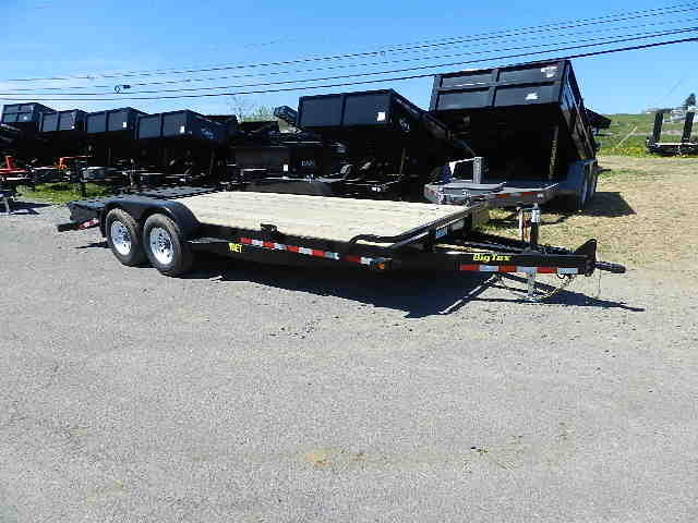 a big tex flatbed trailer is parked on the side of the road