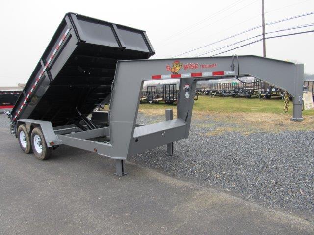 a dump trailer is parked on the side of the road .