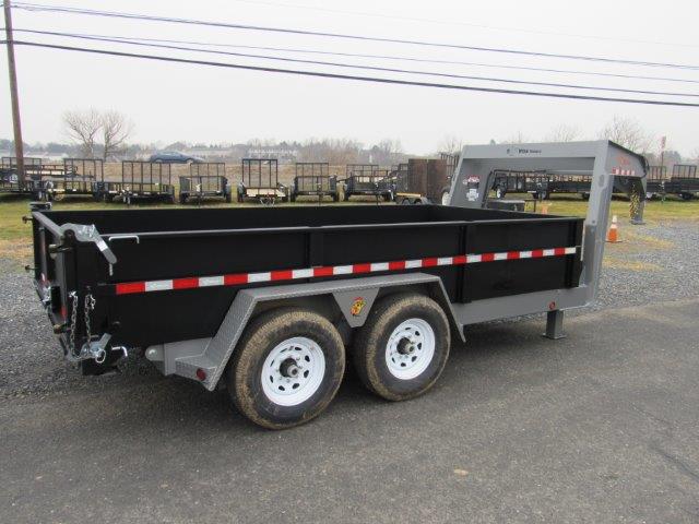 a dump trailer is parked on the side of the road .