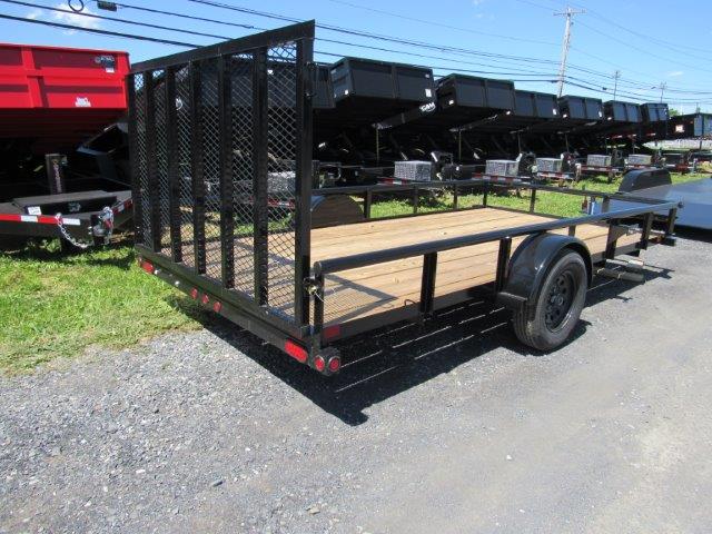 a small trailer is parked on the side of the road .