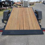 a Bwise trailer with a wooden deck parked on the side of the road