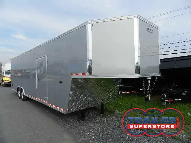a silver Car Mate enclosed gooseneck trailer