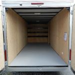 the inside of an empty Care Mate trailer with the doors open