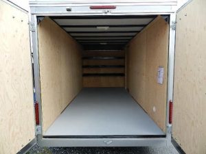 the inside of an empty Care Mate trailer with the doors open