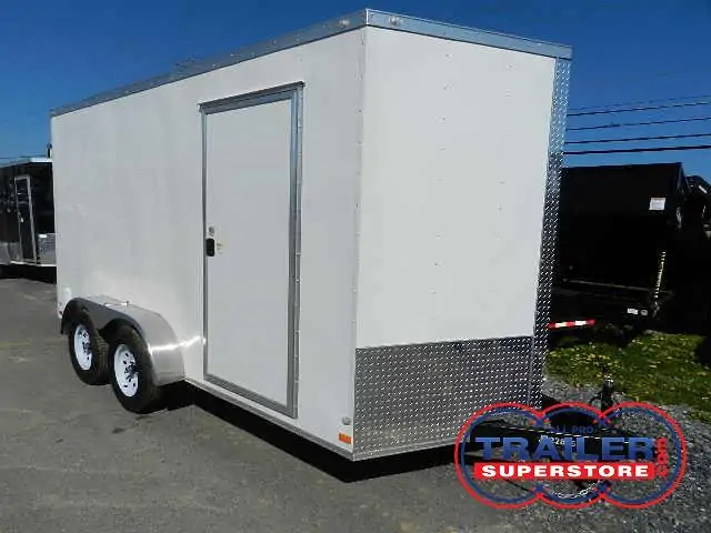 a white trailer is parked on the side of the road