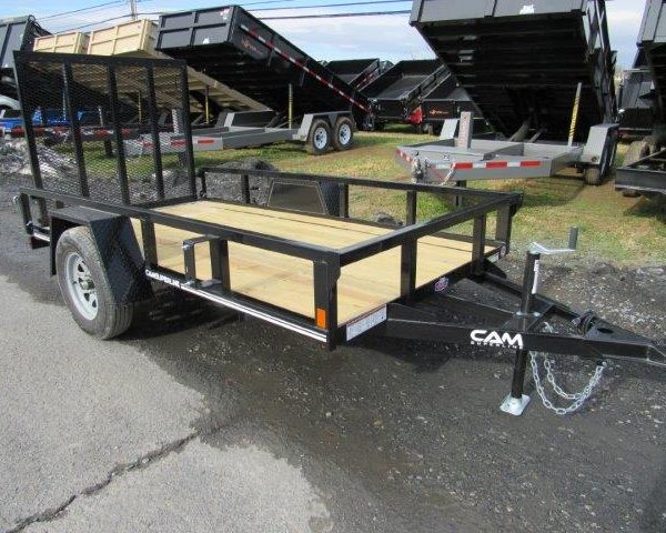 a trailer with a wooden deck is parked on the side of the road .