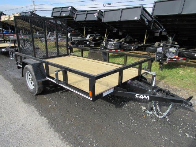 a black trailer with a wooden deck is parked on the side of the road