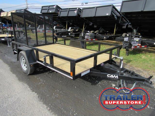 a black trailer with a wooden deck is parked on the side of the road