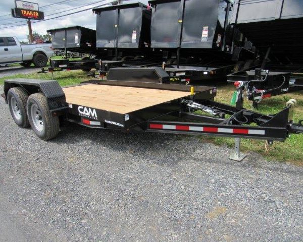 a cam trailer is parked next to a row of dump trailers