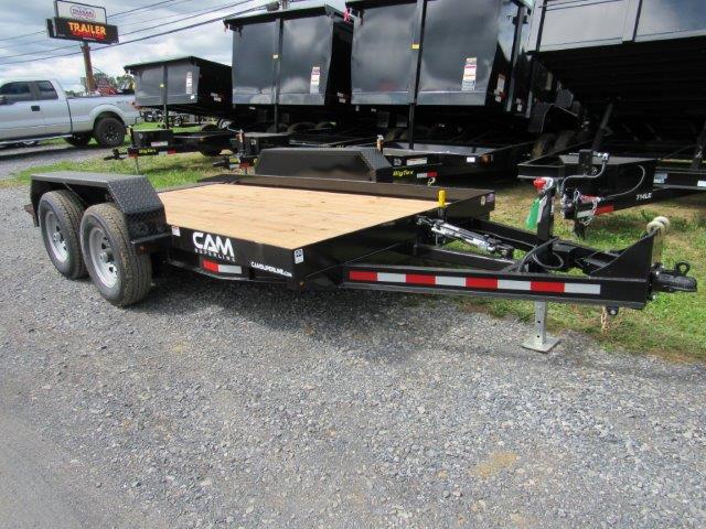 a cam trailer is parked next to a row of dump trailers