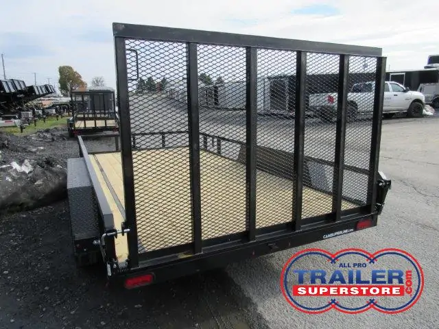 a trailer with a mesh fence is parked on the side of the road
