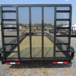 the back of a black trailer with a mesh fence