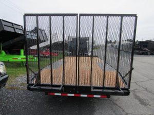 the back of a cam trailer is parked in a parking lot .